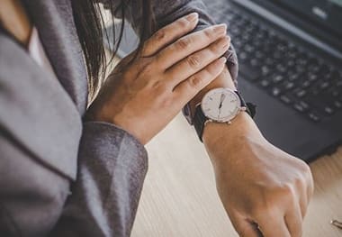 A person with their hands on the wrist of someone