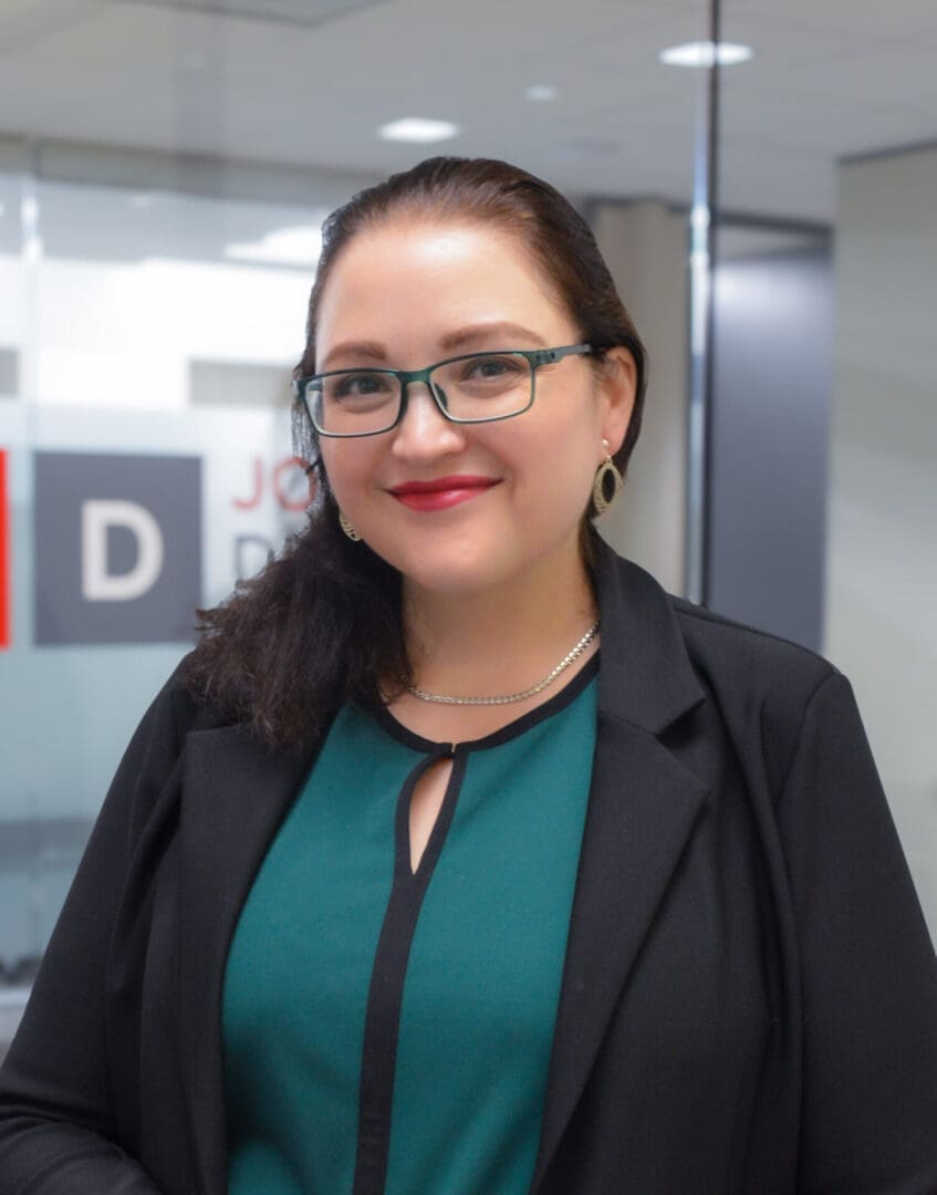 Woman smiling in an office setting.