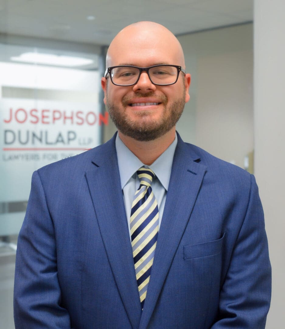 Man in suit smiling at the camera.