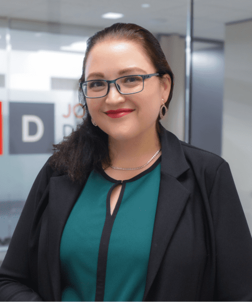 Person smiling in professional office setting.