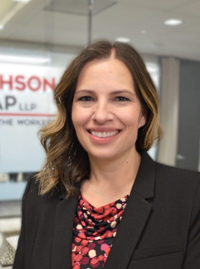 Smiling woman in business attire indoors.