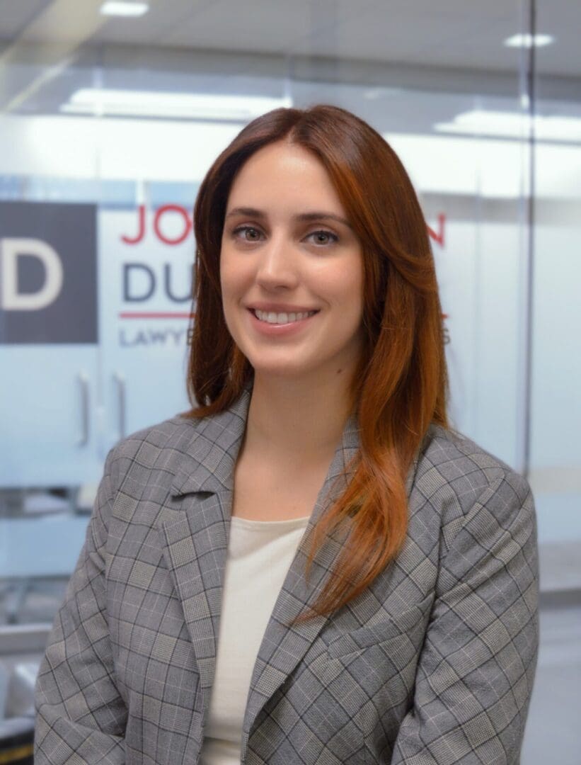 Woman in office wearing a checkered blazer.