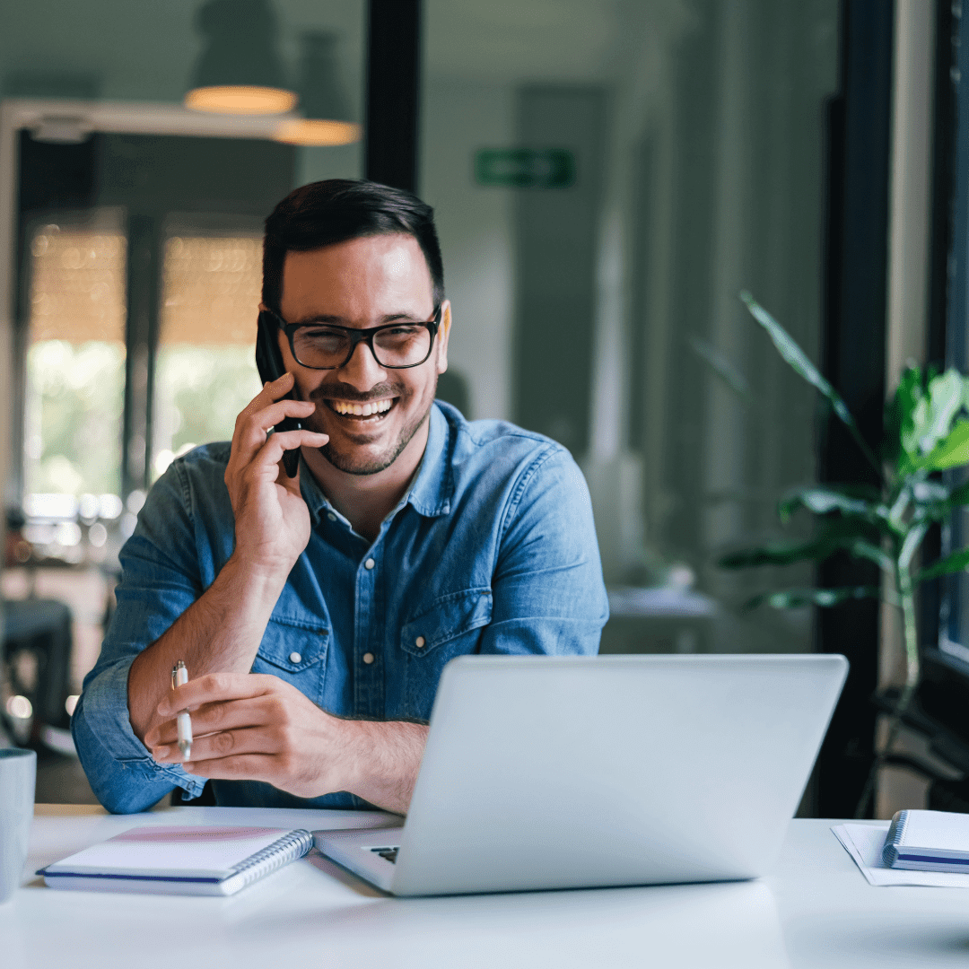 Man talking on phone at desk.