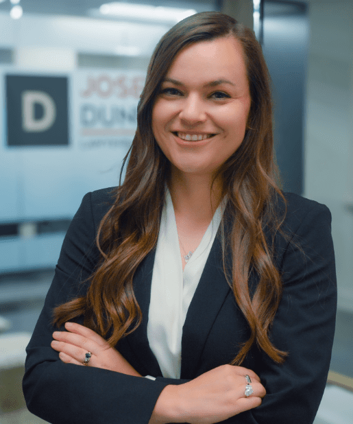 Smiling woman in a business suit indoors.