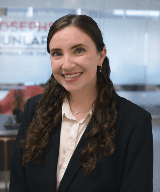 Smiling woman in a business suit indoors.
